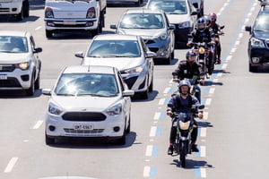 imagem colorida do trânsito de São Paulo com a novidade da faixa azul para motociclistas. Metrópoles