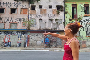 imagem colorida mostra mulher apontando para quarteirão abandonado no centro de são paulo - metrópoles
