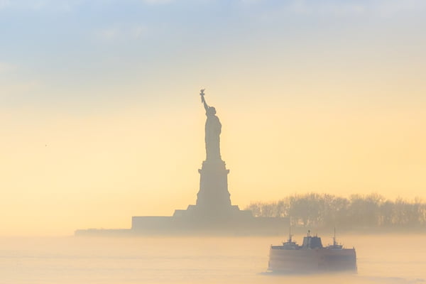 Staten Island Ferry cruises past the Statue of Liberty.