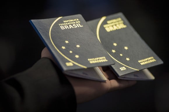Hand holding Brazilian Passport