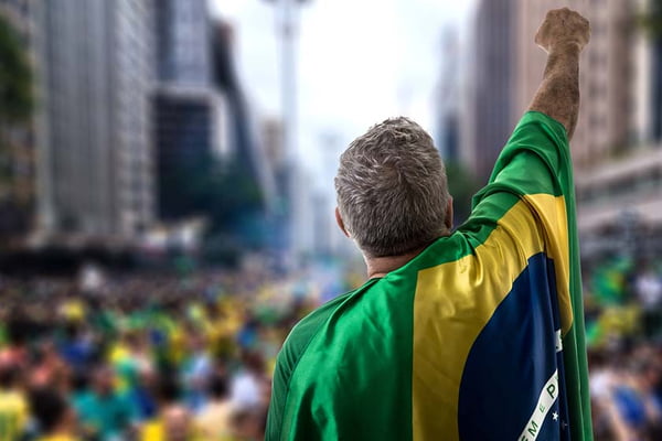 Brazilian senior holding the flag in Sao Paulo
