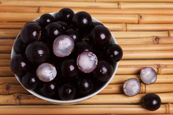 Berry Jaboticaba in bowl on bamboo table