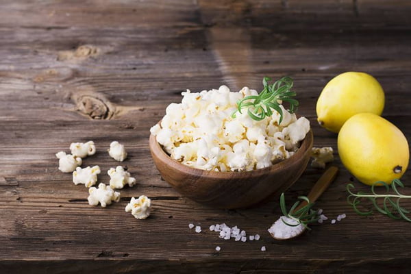 Salty crunchy fresh homemade popcorn flavored with lemon peel and