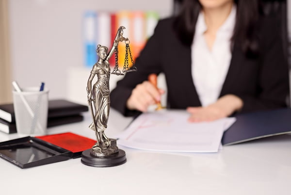 Statuette of Themis –  goddess of justice on lawyer’s desk