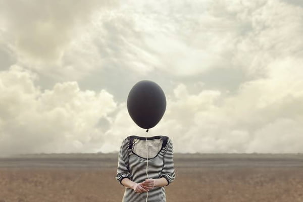 woman’s head replaced by a black balloon
