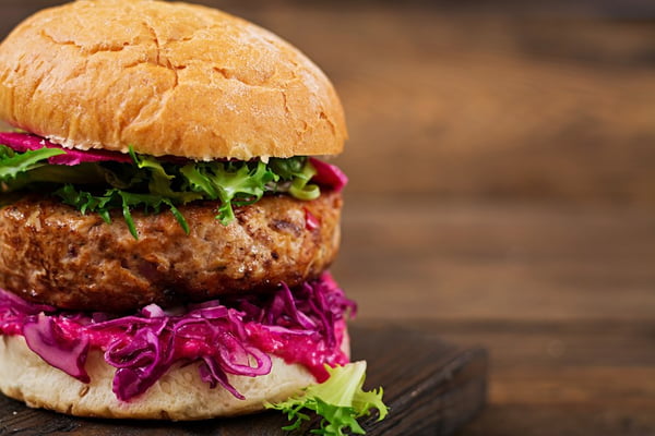 Sandwich hamburger with juicy burgers,  red cabbage and pink sauce