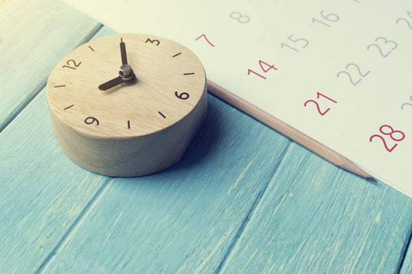 close up of calendar and clock on the table, planning for business meeting or travel planning concept