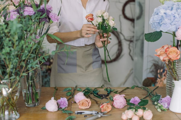 Midsection Of Florist Making Flower Bouquet