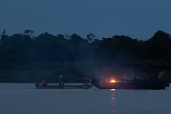 garimpeiro tenta apagar fogo em balsa no Rio Madeira, no Amazonas