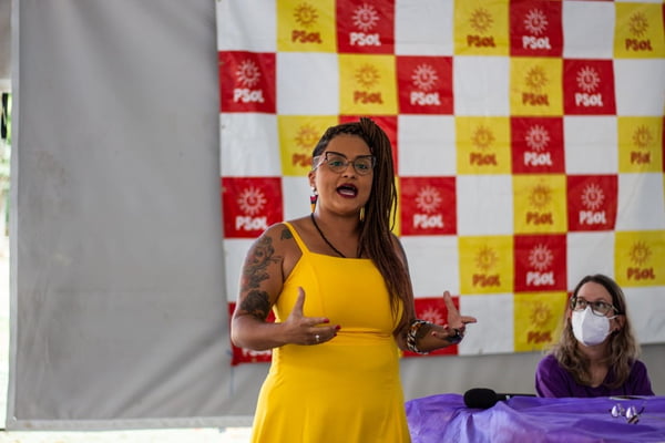 Keka Bagno, do PSOL, deve concorrer ao Buriti em 2022. Ela é uma mulher negra, de tranças e óculos, com vestido amarelo - Metrópoles
