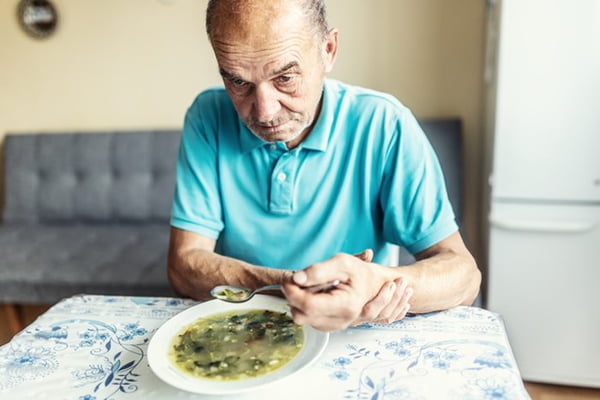Old man in blue shirt sitting and eating - Metropolis