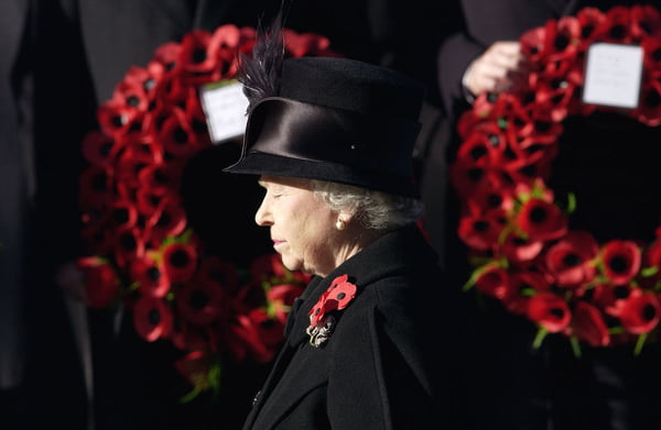 Rainha Elizabeth II vestindo roupa preta para luto cercada por papoulas vermelhas no cenotáfio em Whitehall