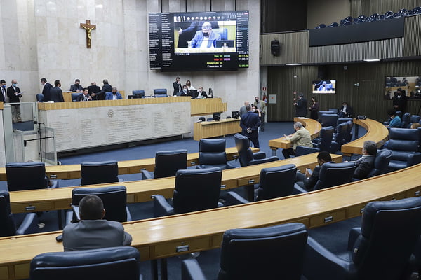 Imagem colorida do plenário da Câmara Municipal de São Paulo, com movimentação de parlamentares. No painel eletrônico, um deputado vereador aparece falando- Metrópoles