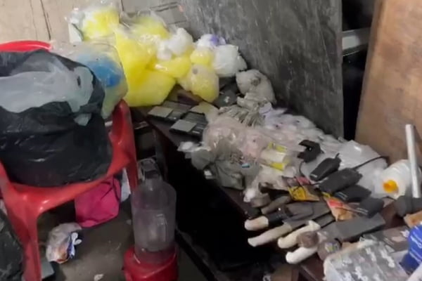 Imagem colorida de drogas e utensílios espalhados em cima de uma bancada preta dentro de uma chamada Casa Bomba em Santos - Metrópoles