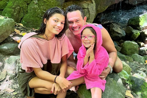 foto colorida de homem ao lado de jovem e criança - metrópoles