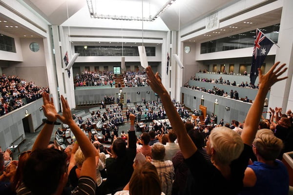 Members celebrate before the passing of the Marriage Amendment Bill in the House of Representatives at Parliament House in Canberra